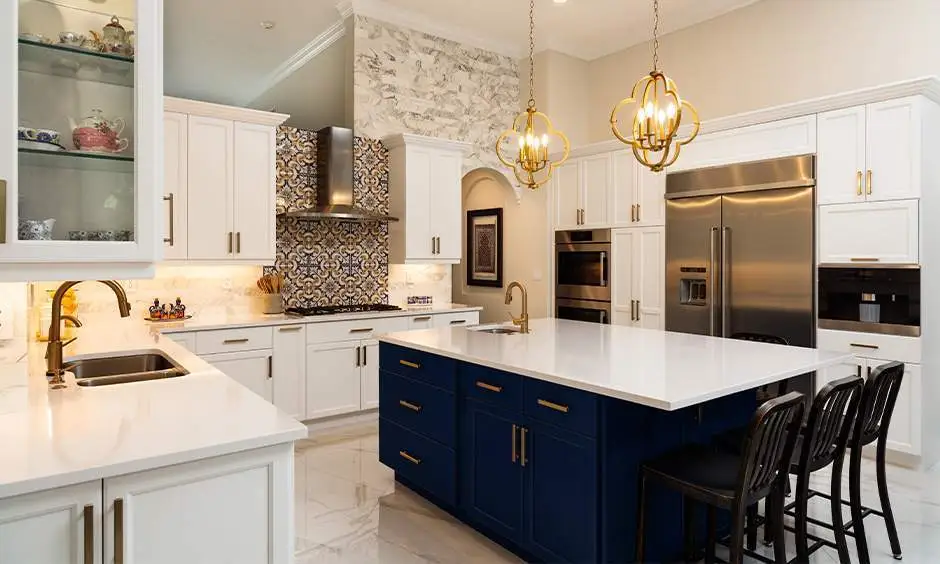 Luxury kitchen in a Yelahanka Bengaluru apartment with dark stone worktops, tall integrated cabinetry and a breakfast counter